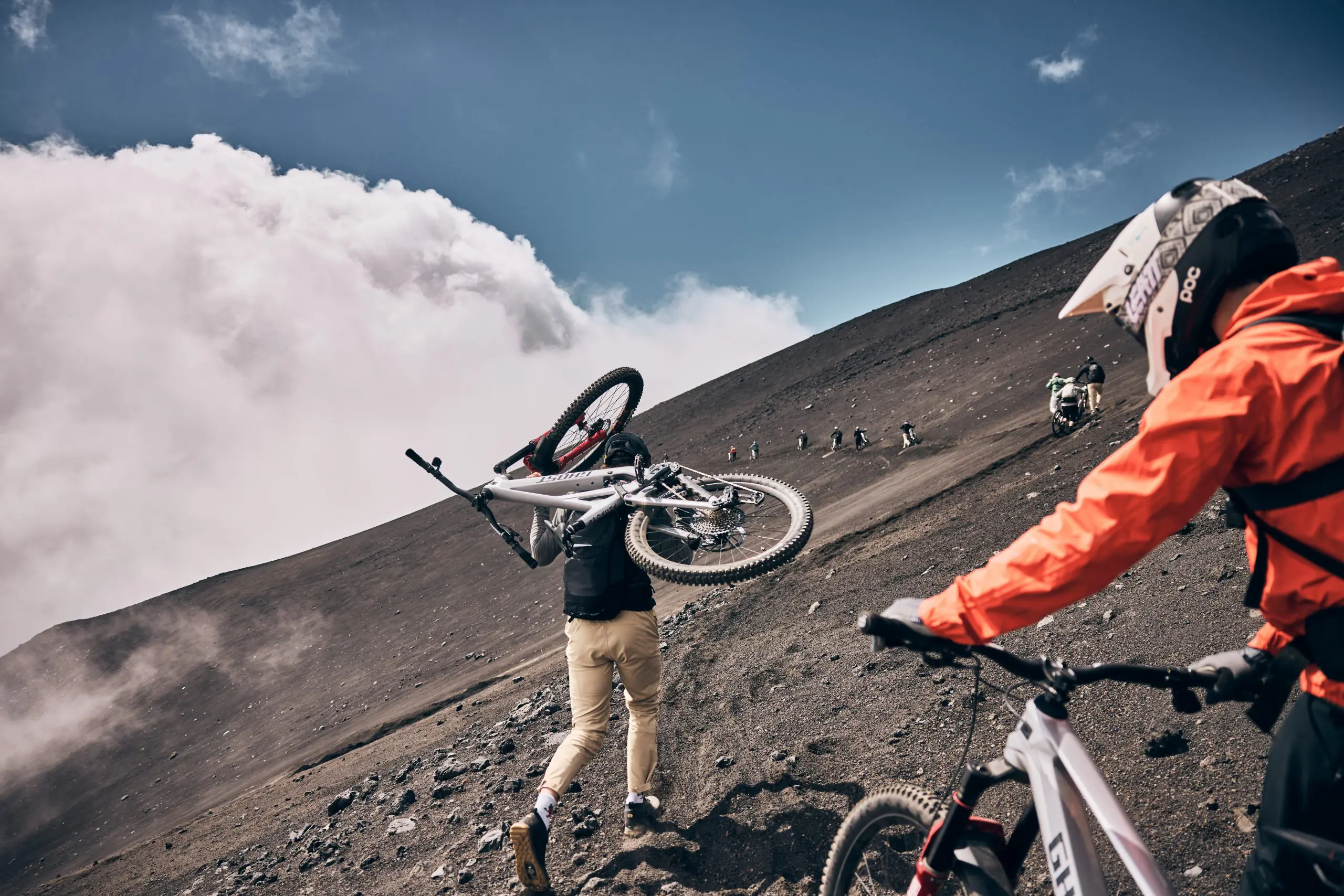 Mountain bikers on a steep trail during Mountain Bike Press Camp, showcasing Mountain Bike Marketing Agency and Event Planner activities. LOAM.