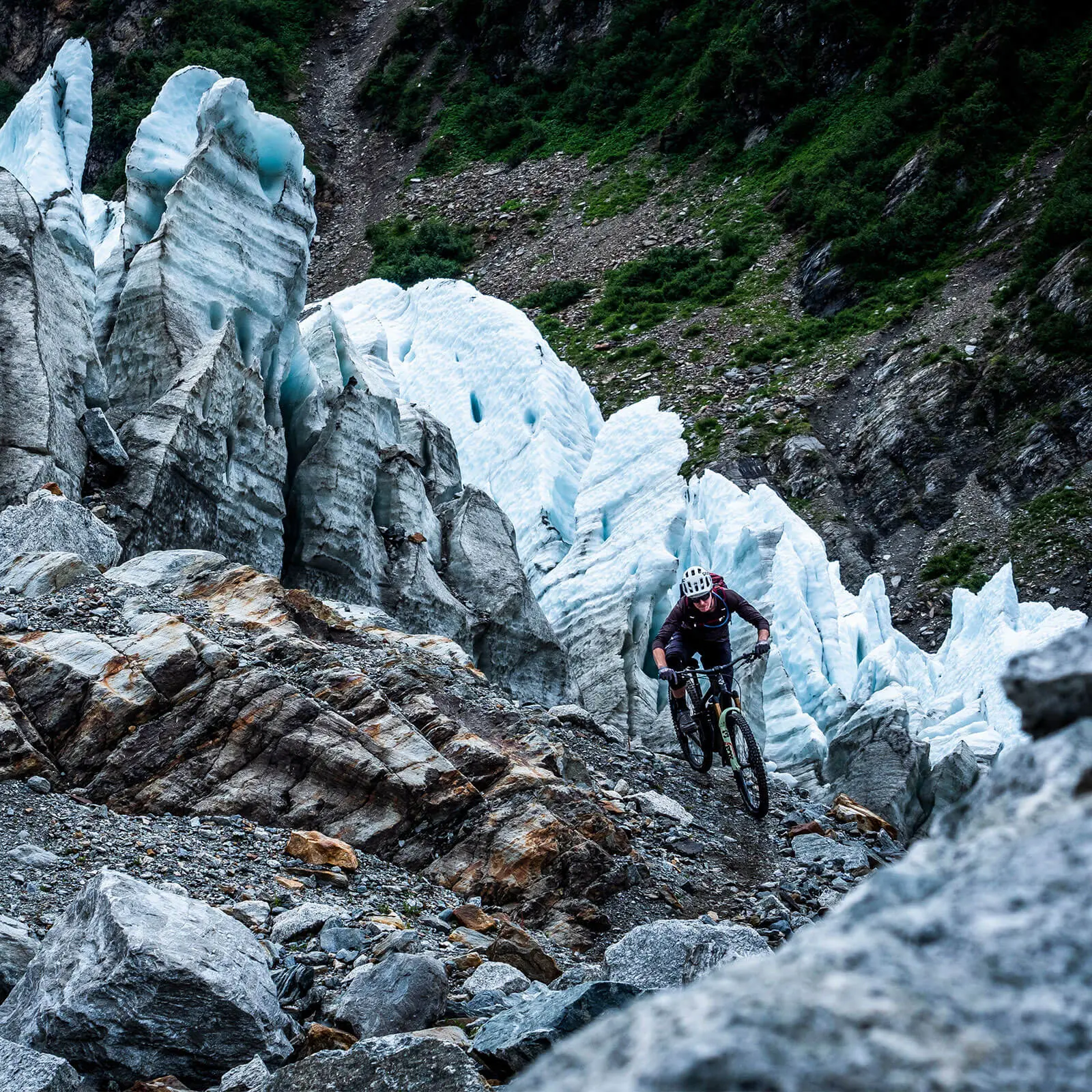 Mountain biker navigating rocky terrain, symbolizing Mountain Bike Ambassador Management, Mountain Bike Marketing Agency, and Mountain Bike Event Planner. LOAM.