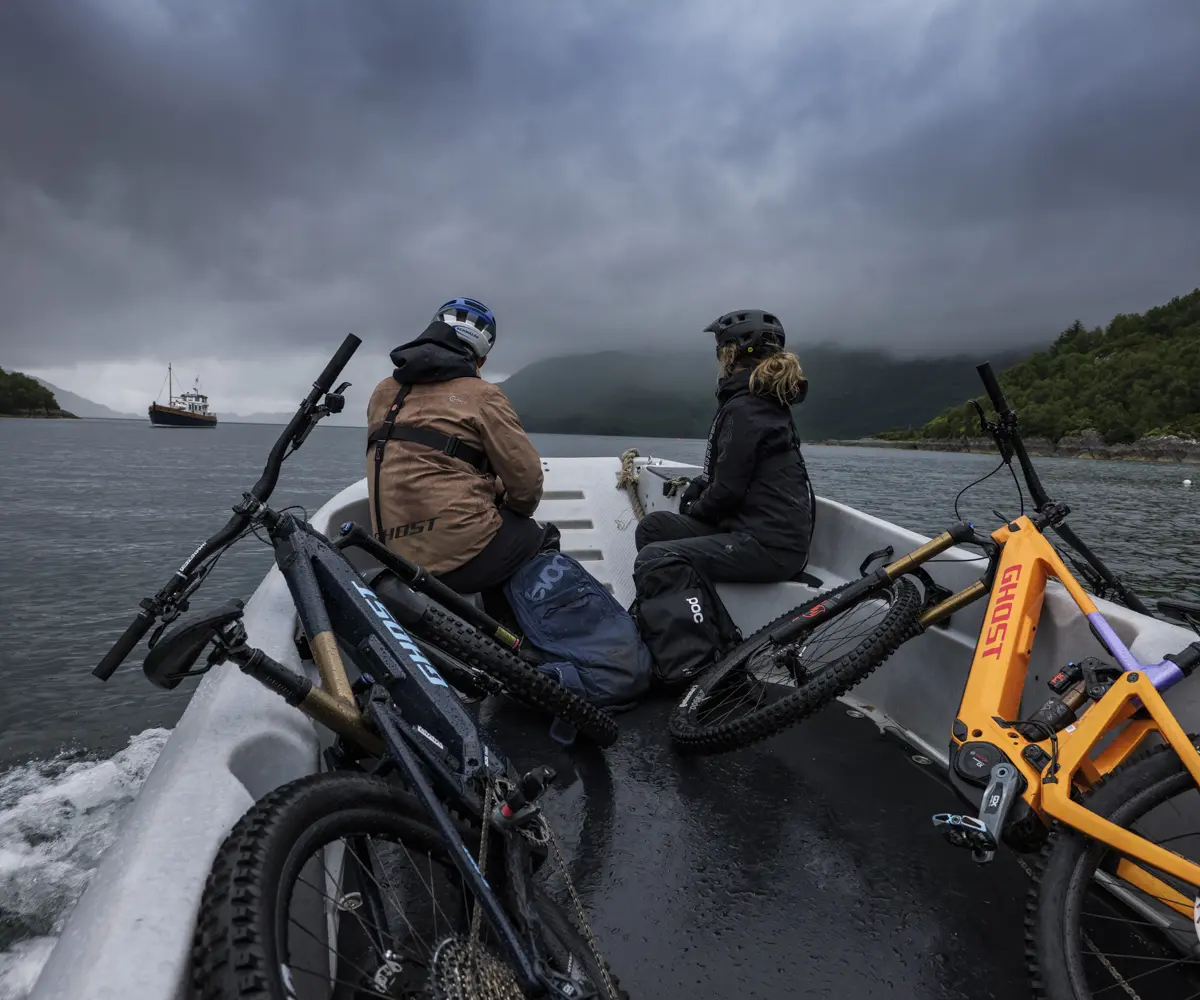 Mountain bikers with bikes on a boat, ideal for mountain bike content creation, marketing agency strategies, and event planner logistics. LOAM.