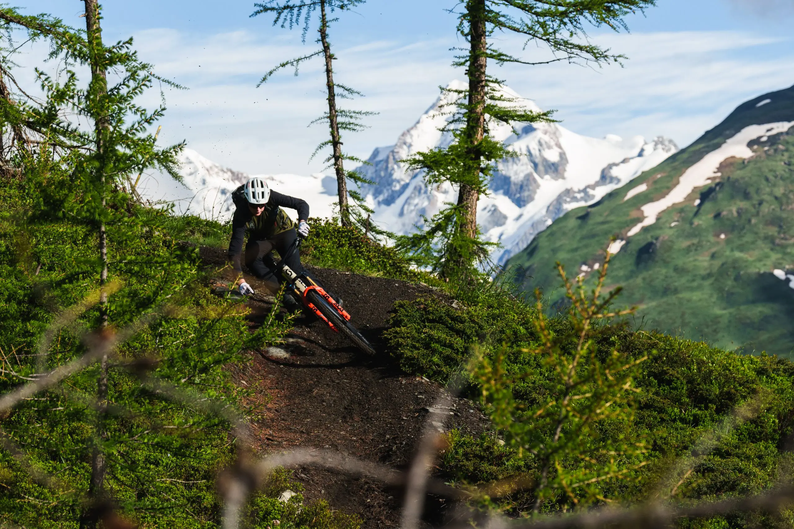 Mountain biker navigating a trail, showcasing mountain bike ambassador management, marketing agency services, and event planning in scenic terrain. LOAM.