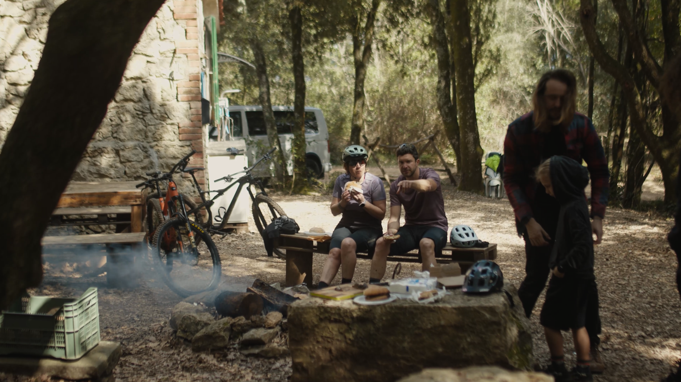 Mountain biking team at forest camp planning content creation, marketing strategy, and logistical support for upcoming event and press camp. LOAM.