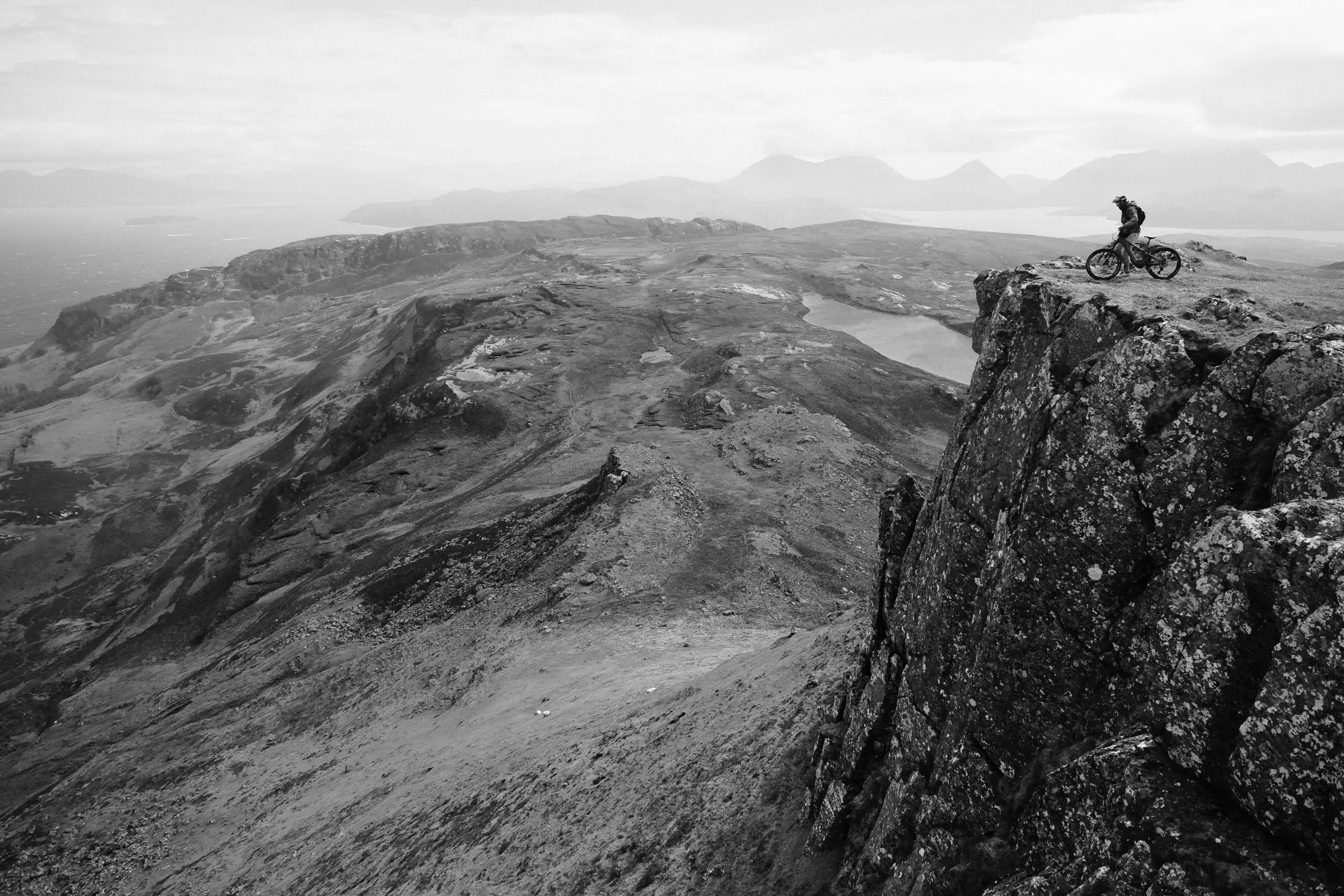 Mountain biker on cliff during Euan Wilson's Global Trail Adventures in 