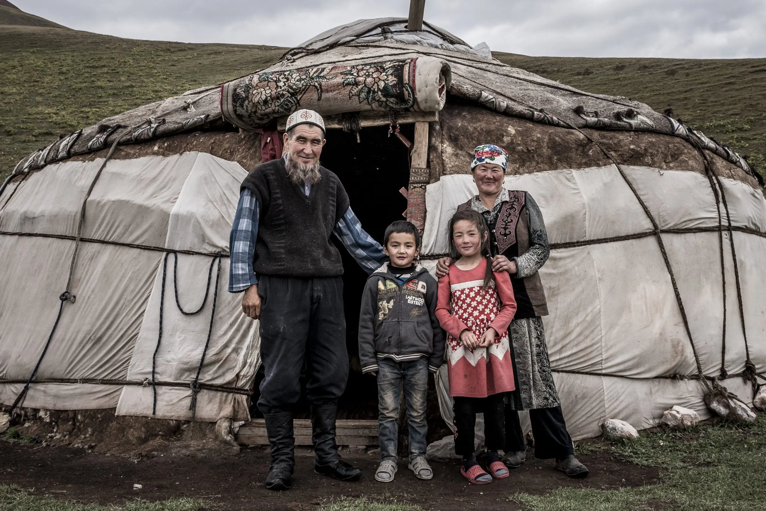 Family in front of a traditional yurt on Euan Wilson’s Global Trail Adventures. Around the World With LOAM. Mountain bike cultural exploration. LOAM.