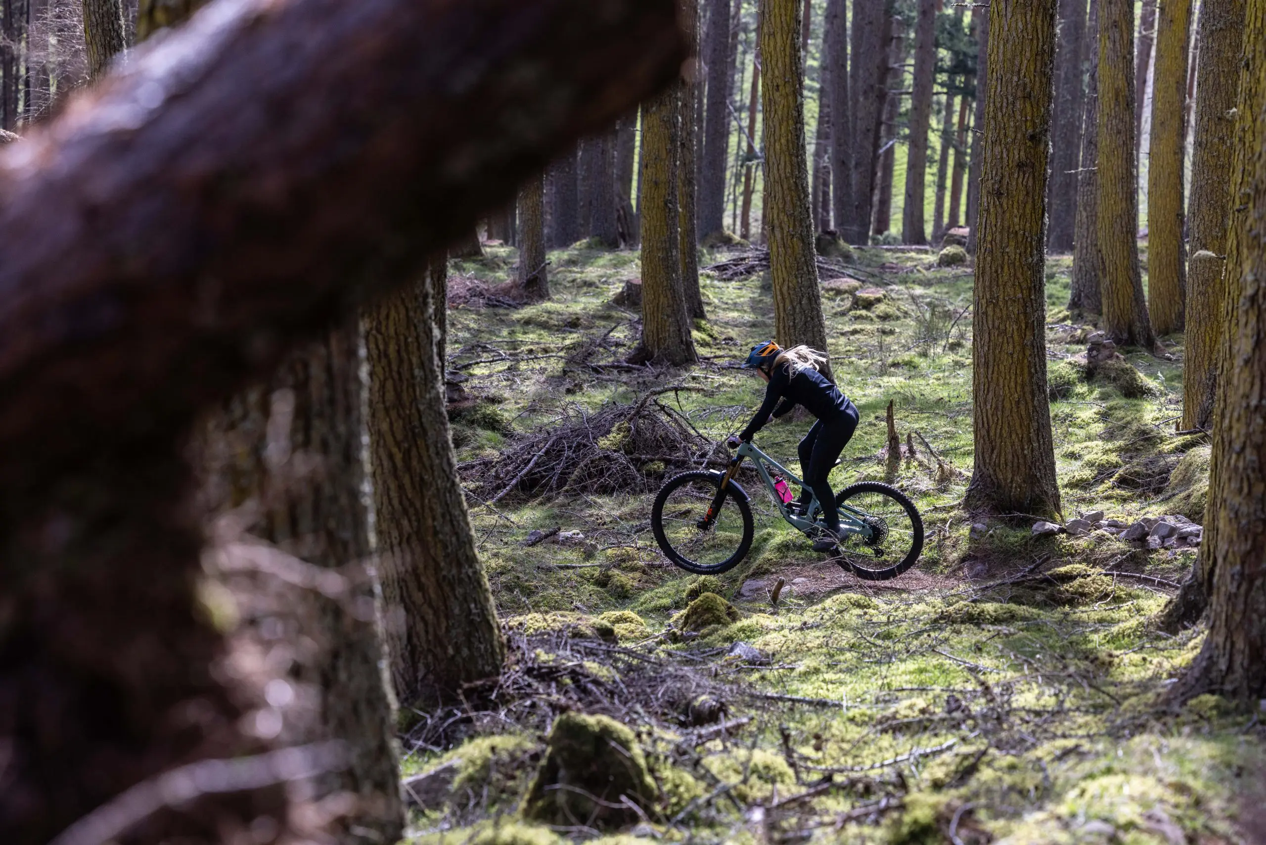 Mountain bike rider in forest, highlighting Mountain Bike Marketing Agency and content creation with Muc-Off Mobile Pressure Washer logistical support. LOAM.