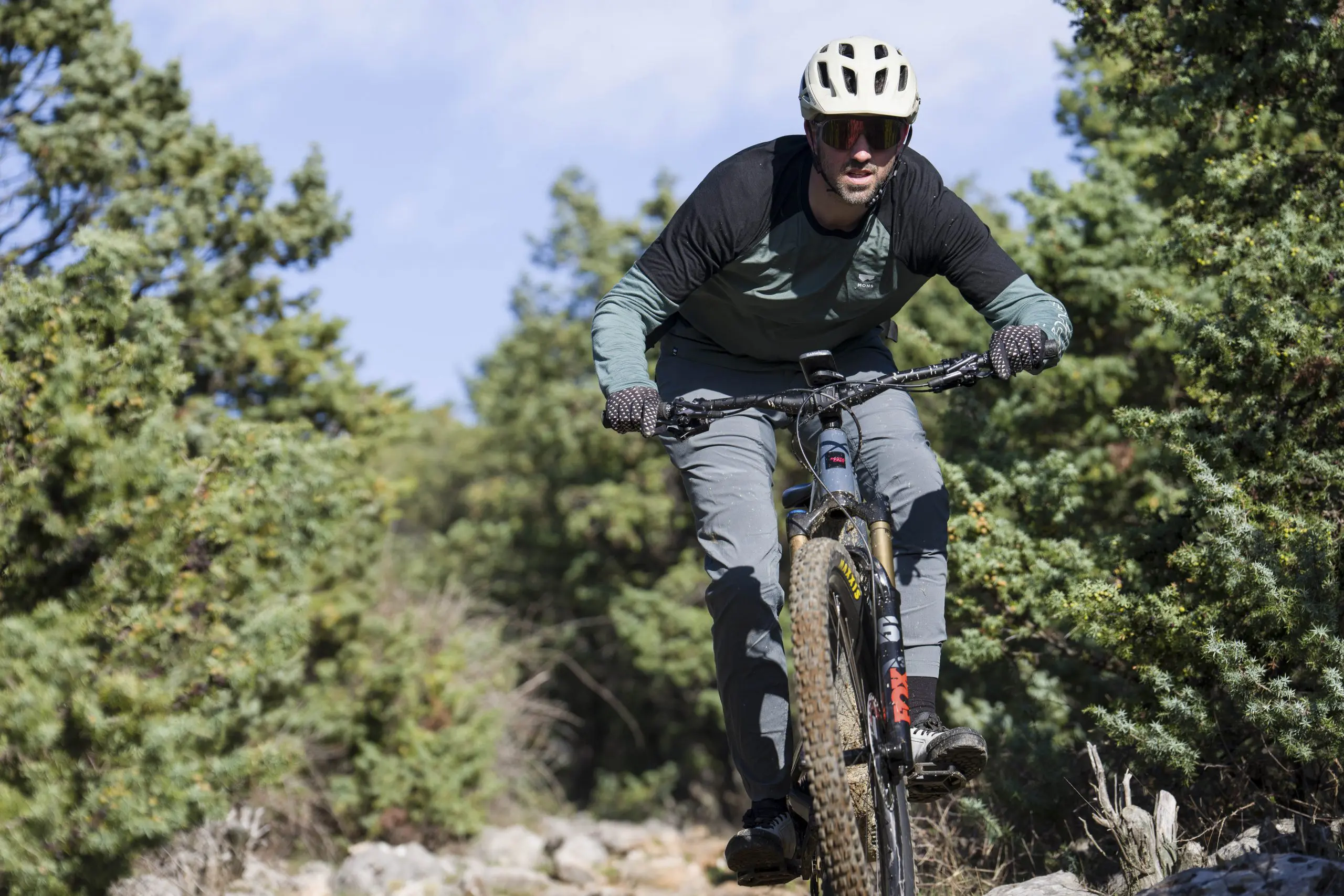 Mountain biker riding through forest, ideal for Mountain Bike Press Camp, showcasing Mountain Bike Marketing Agency and Content Creation expertise. LOAM.