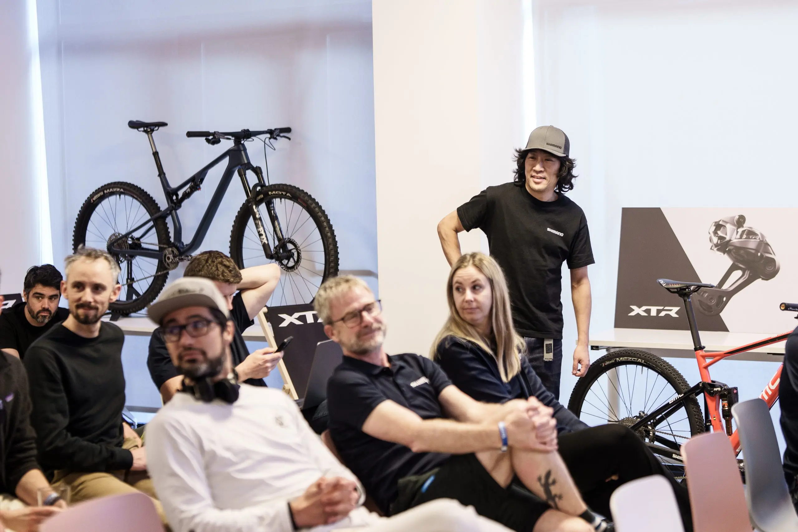 Mountain Bike Press Camp attendees engage in planning discussions. Focus on mountain bike marketing, content creation, and logistical support. LOAM.