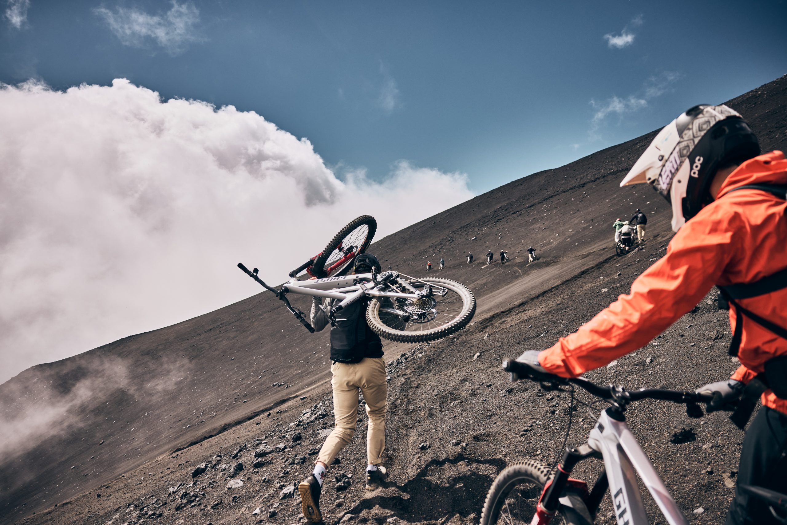 Mountain bikers on a steep trail during Mountain Bike Press Camp, showcasing Mountain Bike Marketing Agency and Event Planner activities. LOAM.