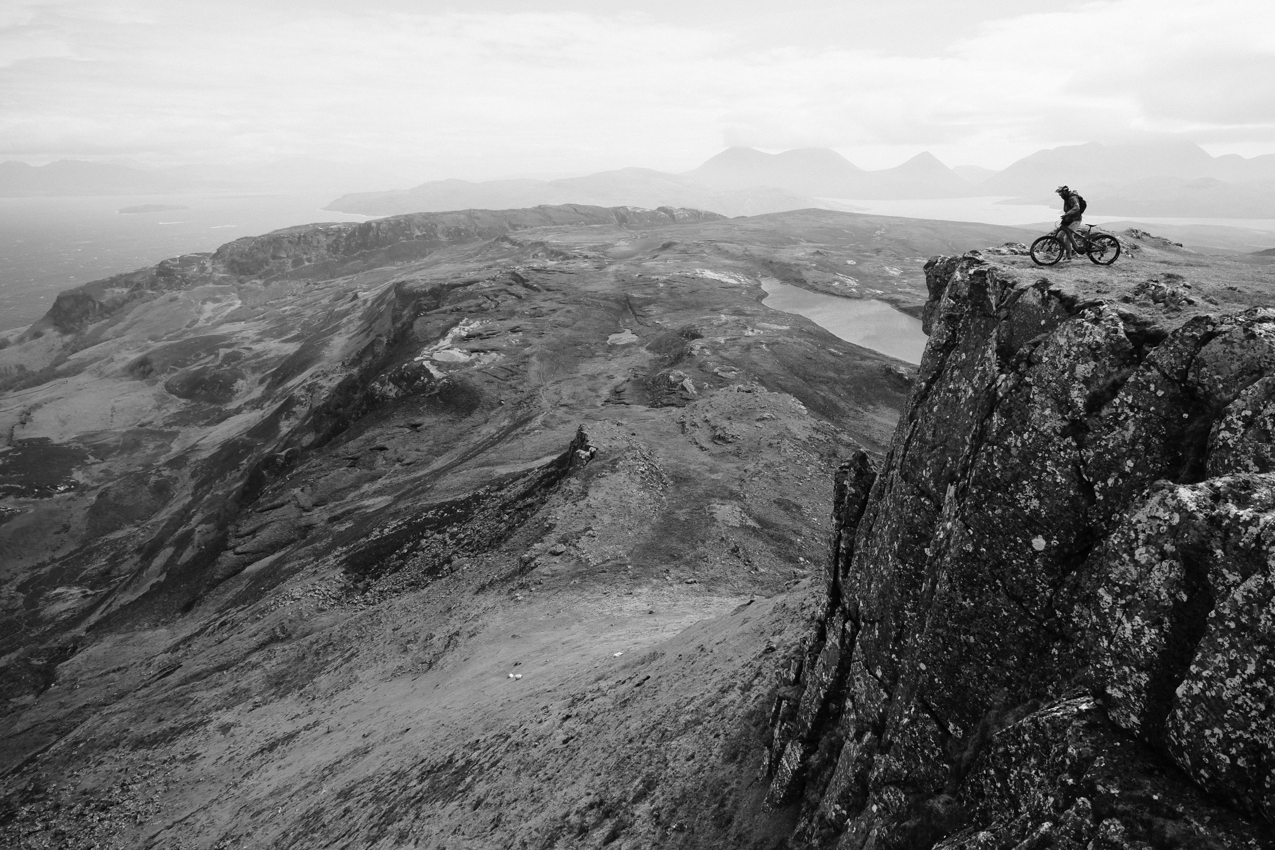 Mountain biker on cliff during Euan Wilson's Global Trail Adventures in 