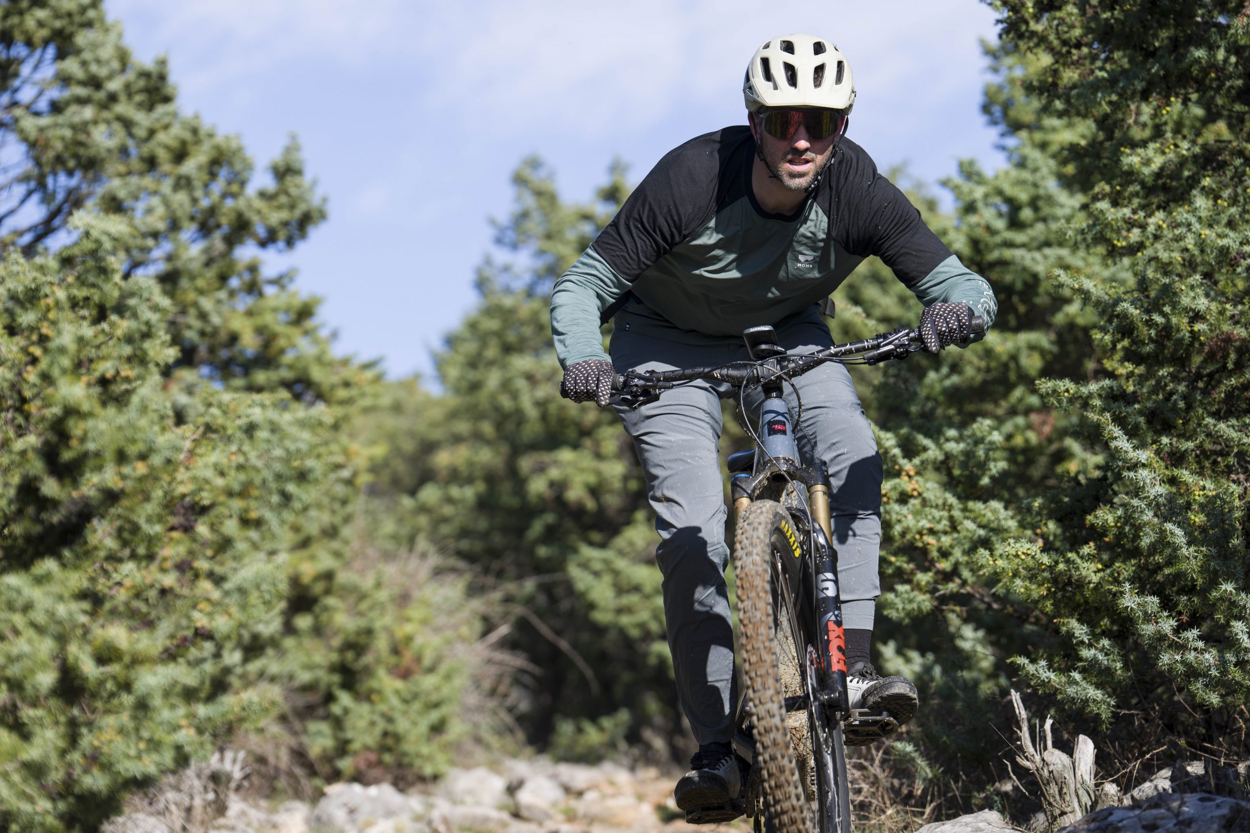 Mountain biker riding through forest, ideal for Mountain Bike Press Camp, showcasing Mountain Bike Marketing Agency and Content Creation expertise. LOAM.