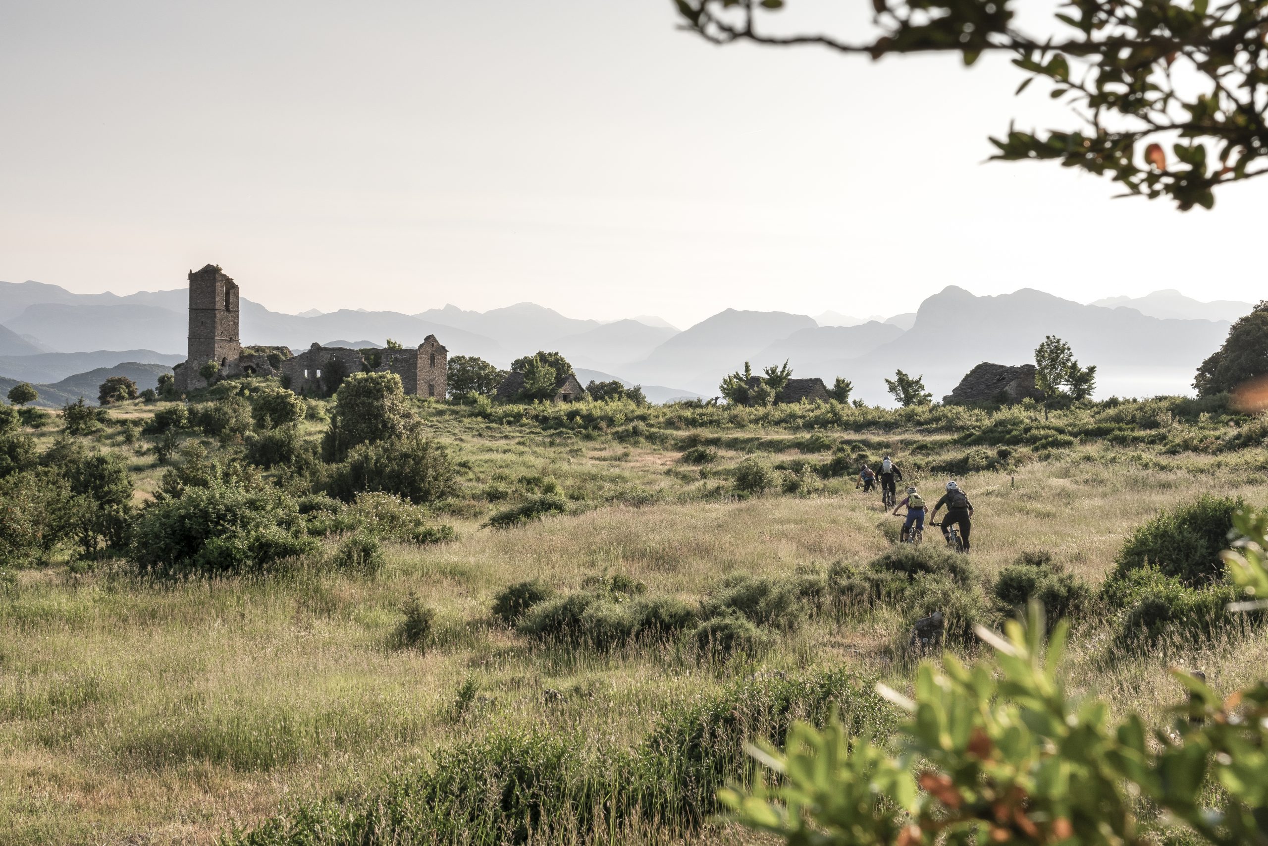 Cyclists at Mountain Bike Press Camp near ruins, showcasing Mountain Bike Marketing Agency strategies and content creation amidst scenic views. LOAM.